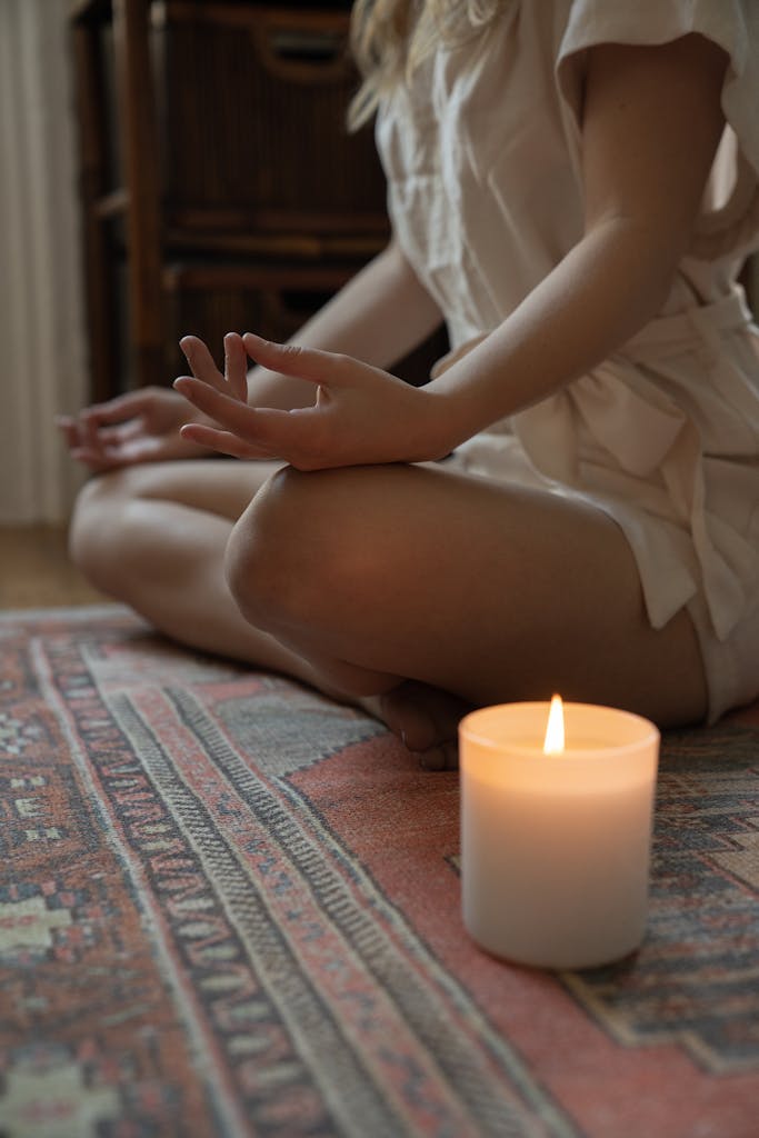 Hi there! Welcome to your Wellness journey. Experience tranquility with a lit candle and meditative pose, ideal for mindfulness practices.